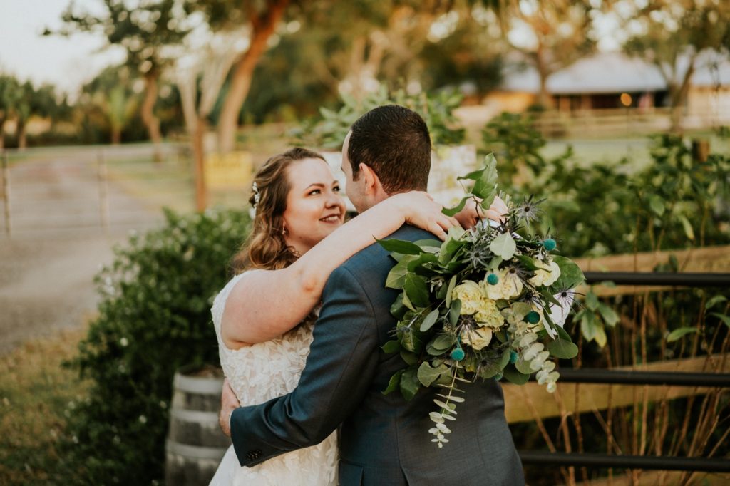 Bride throws bouquet over groom shoulder Florida wedding photography
