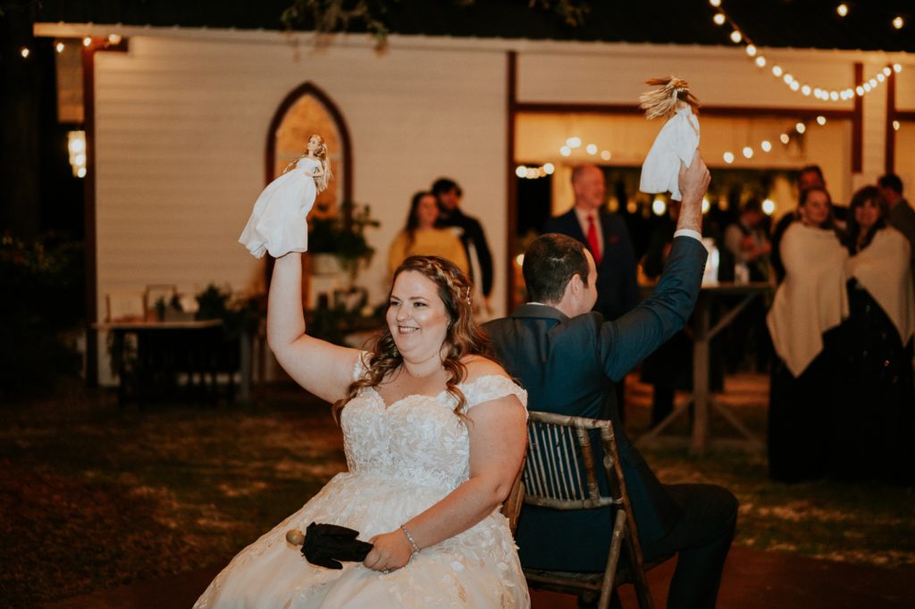 Bride lifts barbie for the wedding shoe game