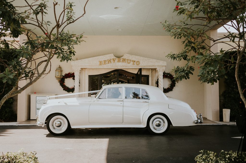 White Rolls Royce classic car arrives at Benvenuto wedding restaurant entrance