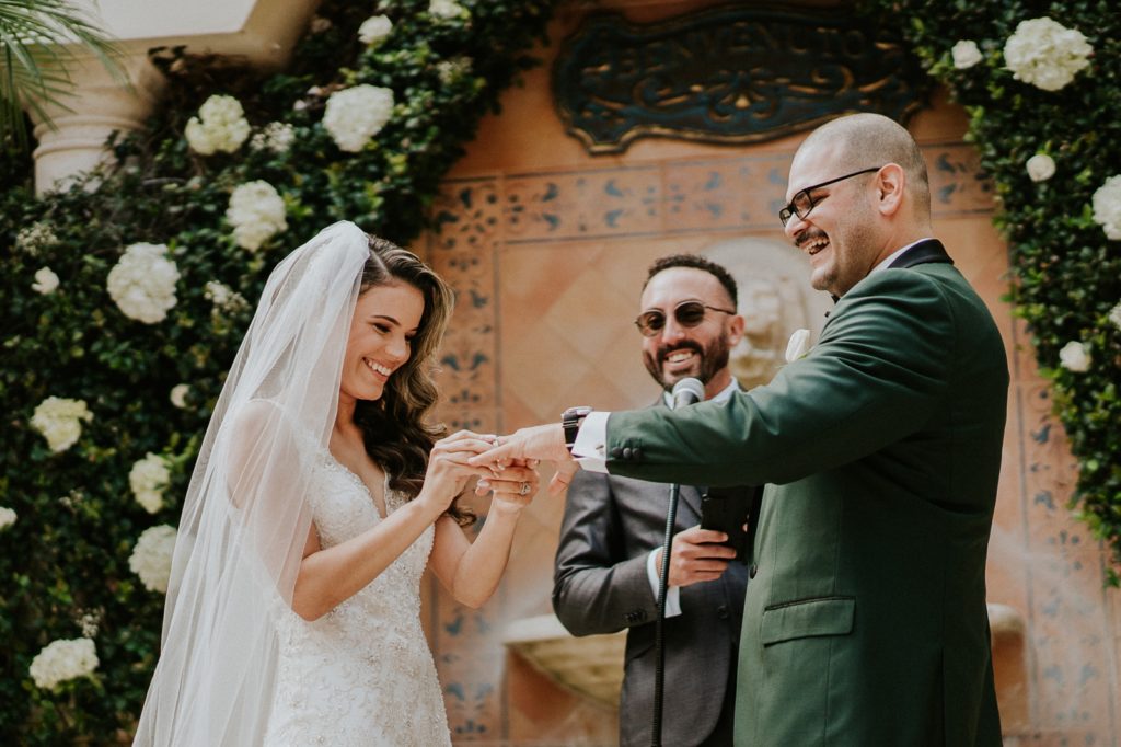 Benvenuto wedding ceremony smiling bride and groom exchange rings