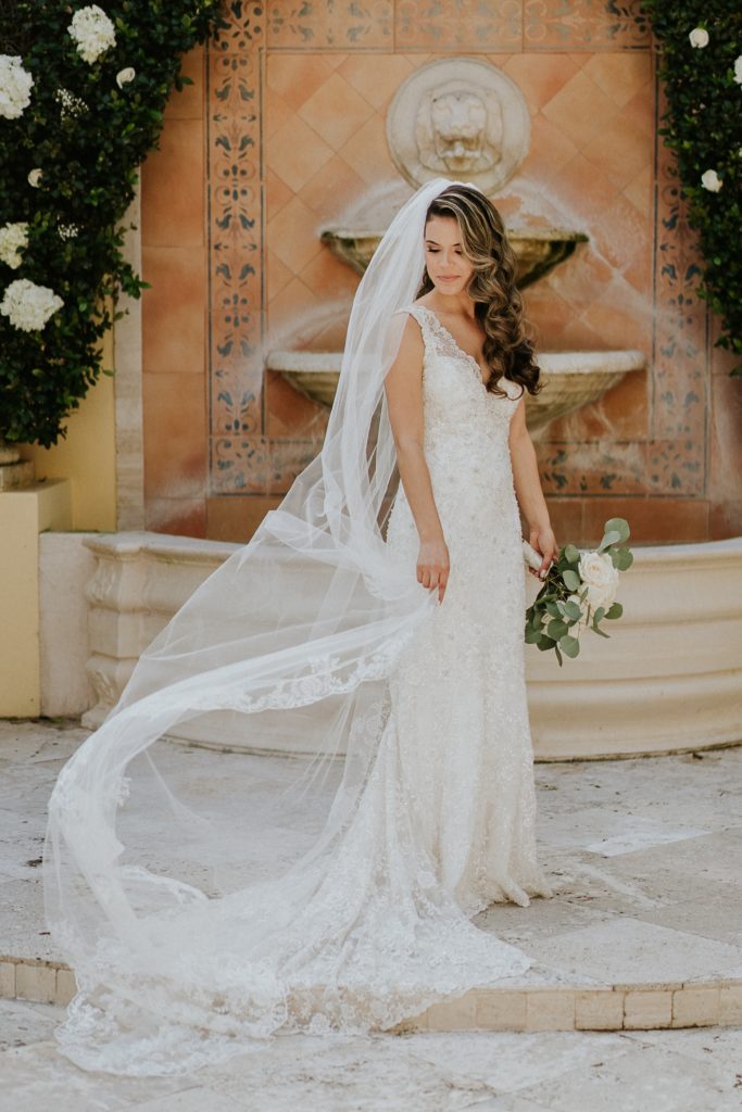 Benvenuto wedding bridal portrait lace cathedral veil blowing in wind