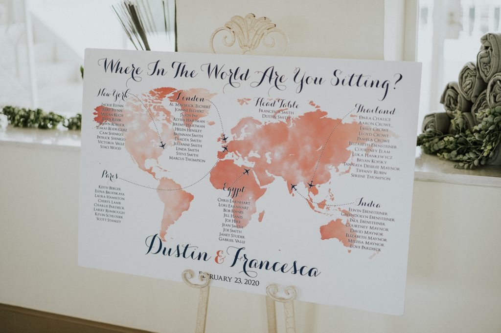 Pink world map travel theme wedding seating chart