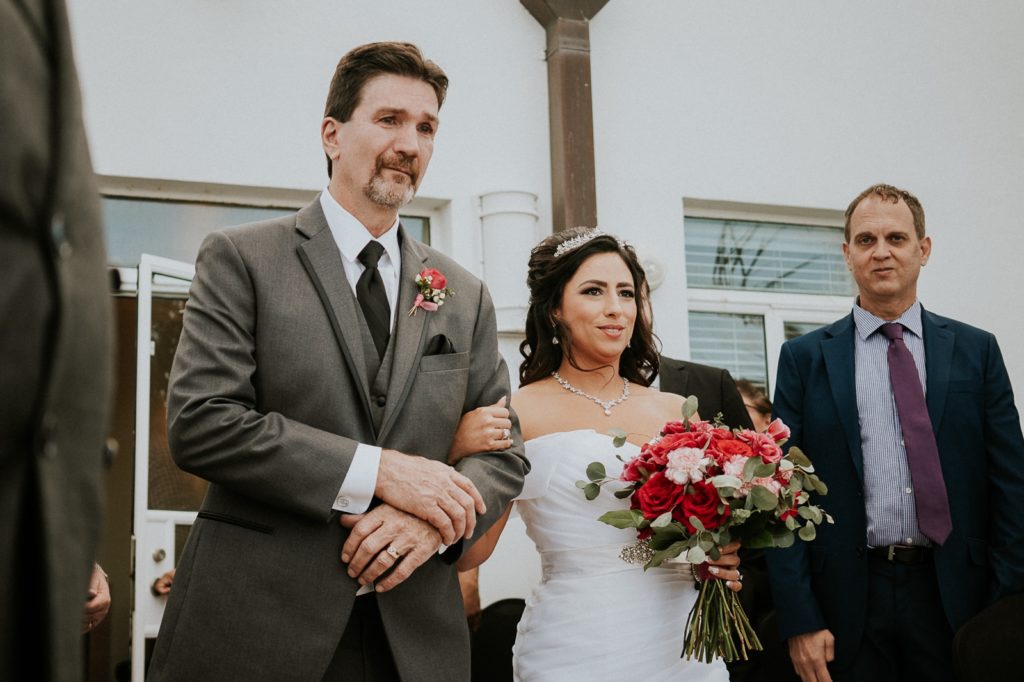Father walking bride down the aisle in wedding ceremony