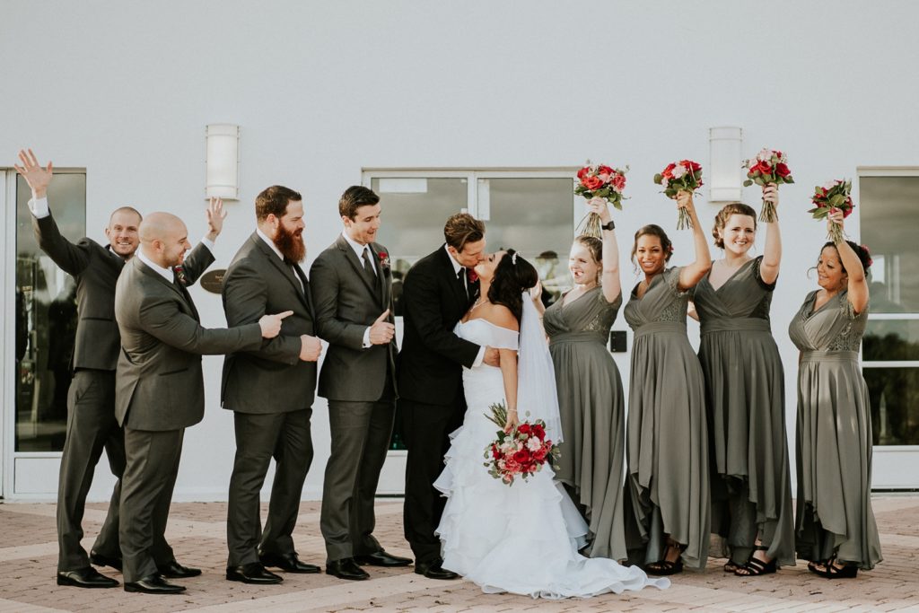 Tuckahoe Mansion wedding couple kiss as bridal party cheers Jensen Beach FL photography