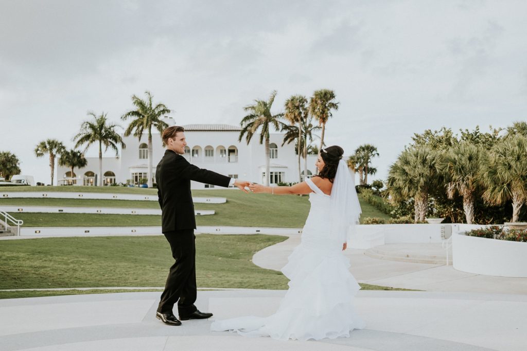 Groom and bride dance in front of the Mansion at Tuckahoe Jensen Beach FL photography