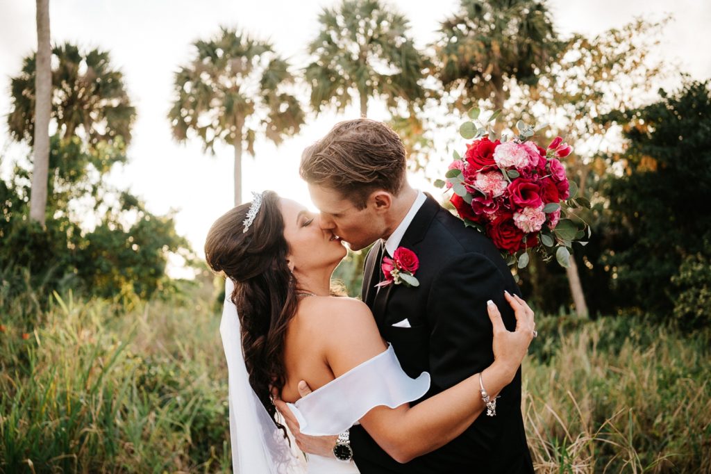 Jensen Beach FL wedding photographer couple kiss at sunset with palm trees