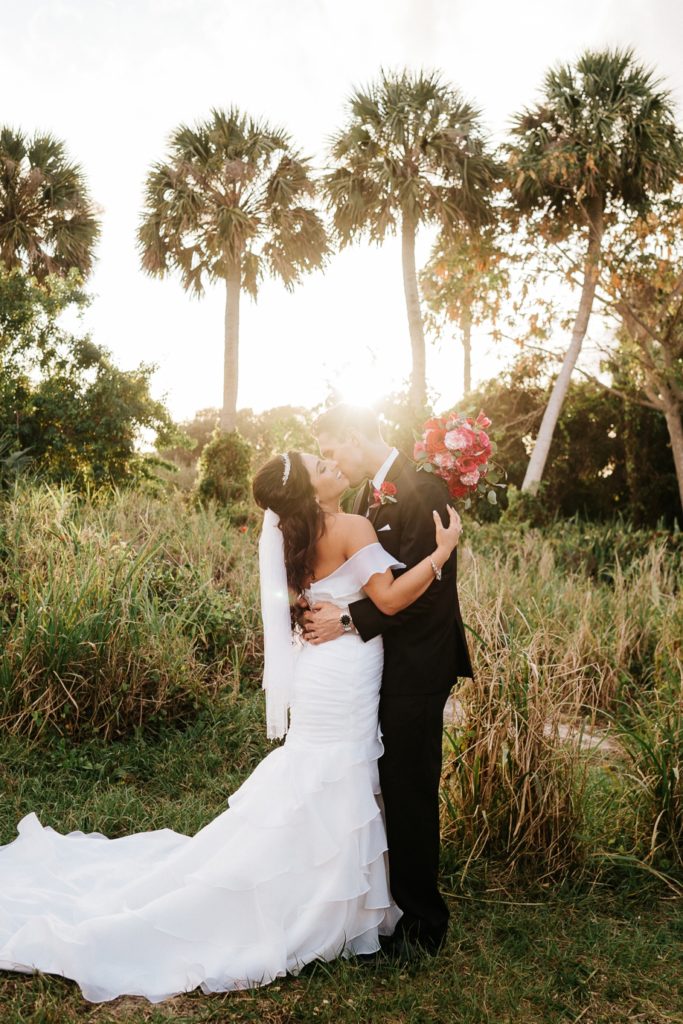 Jensen Beach FL wedding photography couple hug at sunset with palm trees