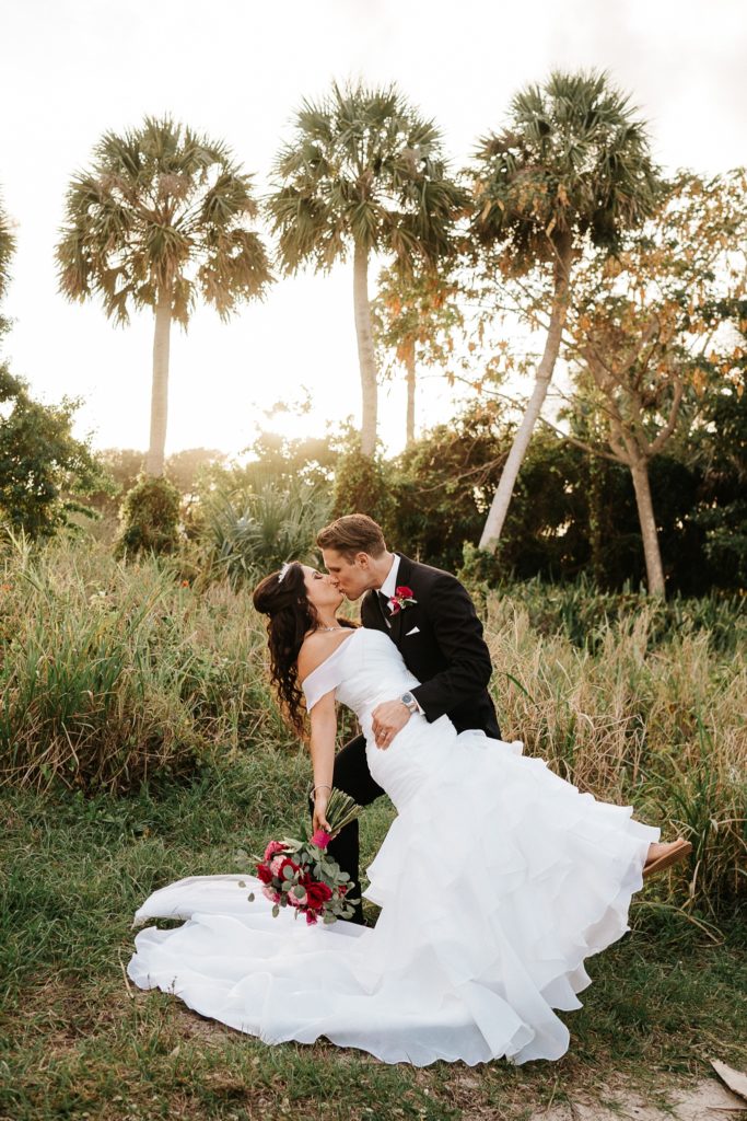 Jensen Beach FL wedding photography couple kiss at sunset with palm trees