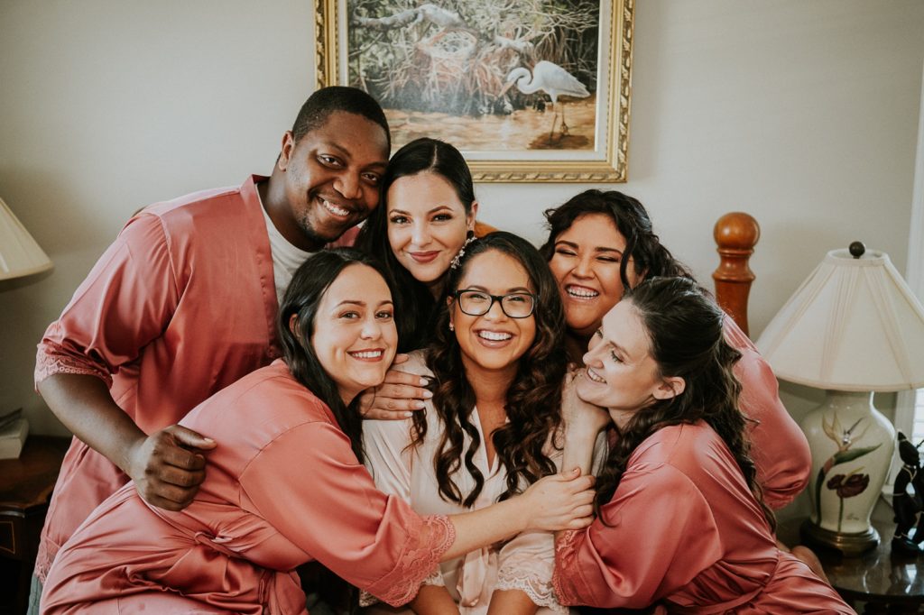 Kai Kai Farm wedding bridesmaids hug bride in bridal suite