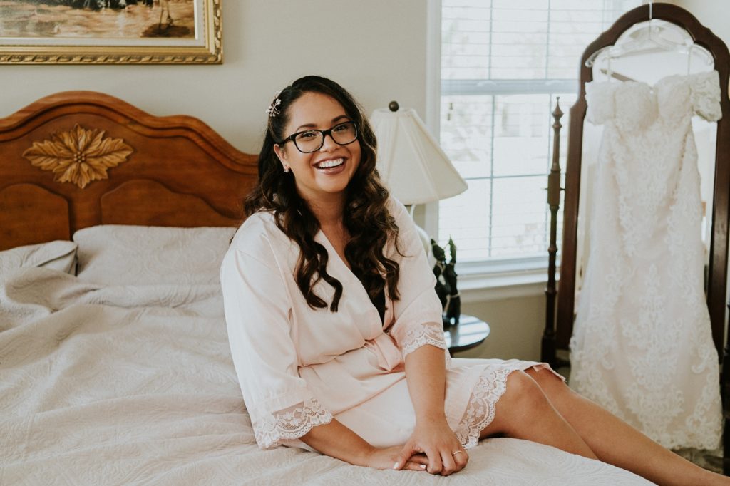 Kai Kai Farm wedding bridal suite with bride in light pink robe and glasses