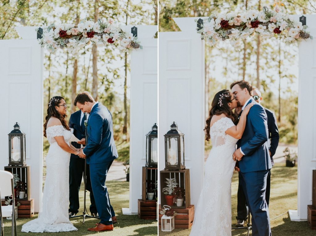 Kai Kai Farm wedding ceremony first kiss in front of white barn door arch