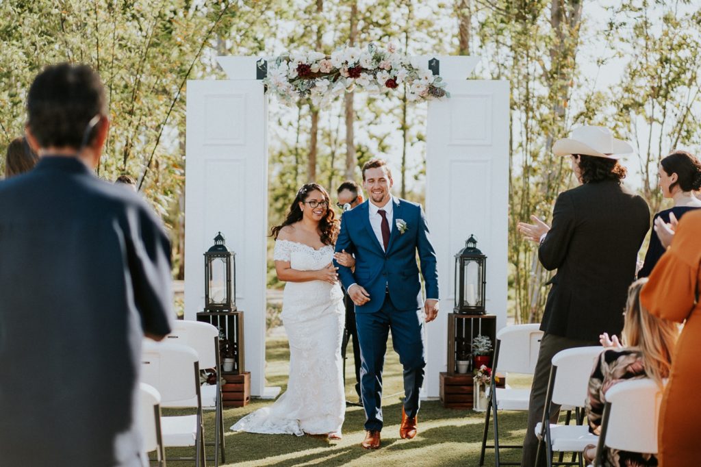 Stuart FL farm wedding ceremony with white barn door arch