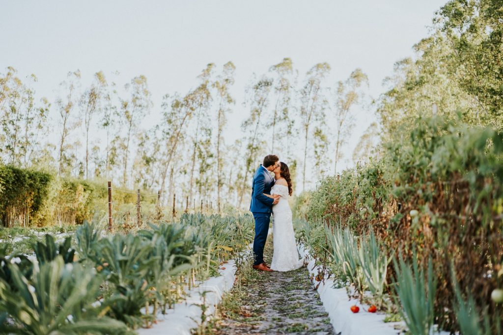 Kai Kai Farm wedding Stuart Florida bride and groom kiss in greenery
