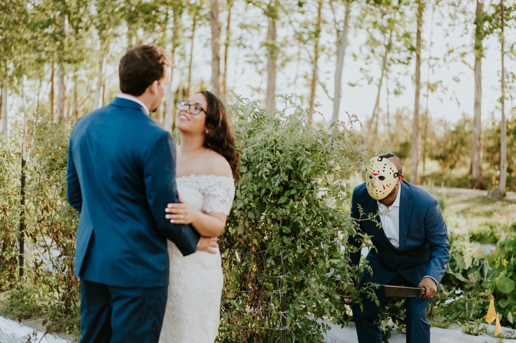 Best man in Jason mask hides behind bush in Friday the 13th wedding at Kai Kai Farm FL