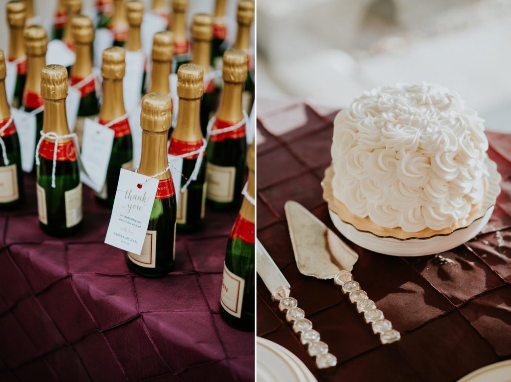Mini champagne bottle wedding favors next to small one tier cake with white icing rosettes