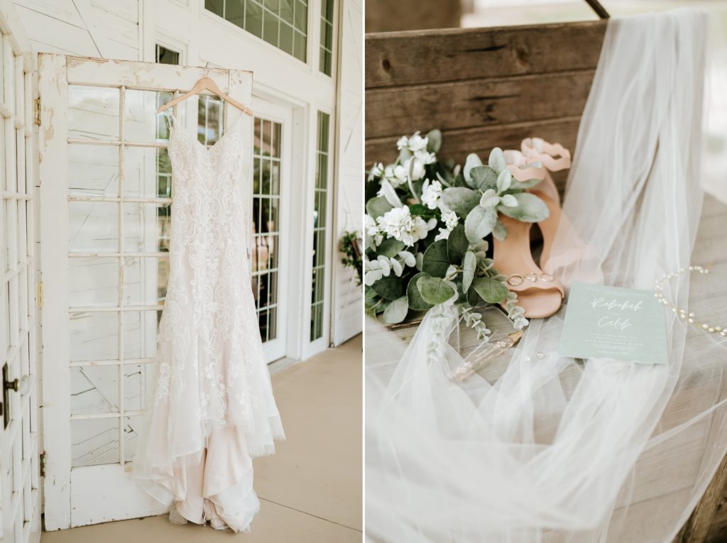 Wedding dress hanging from French doors next to wedding details on top of veil