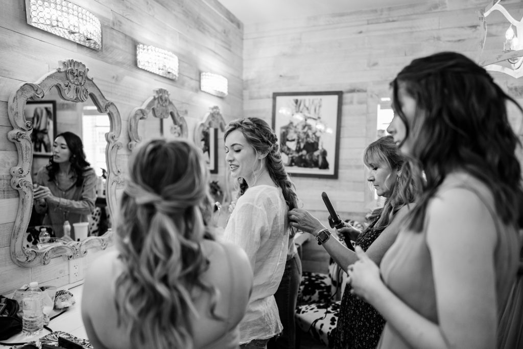 Bride and bridesmaids getting ready in bridal suite