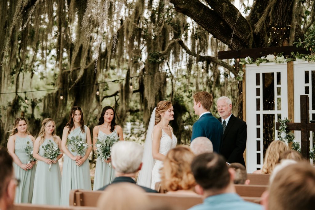 Bride recites vows under spanish moss tree