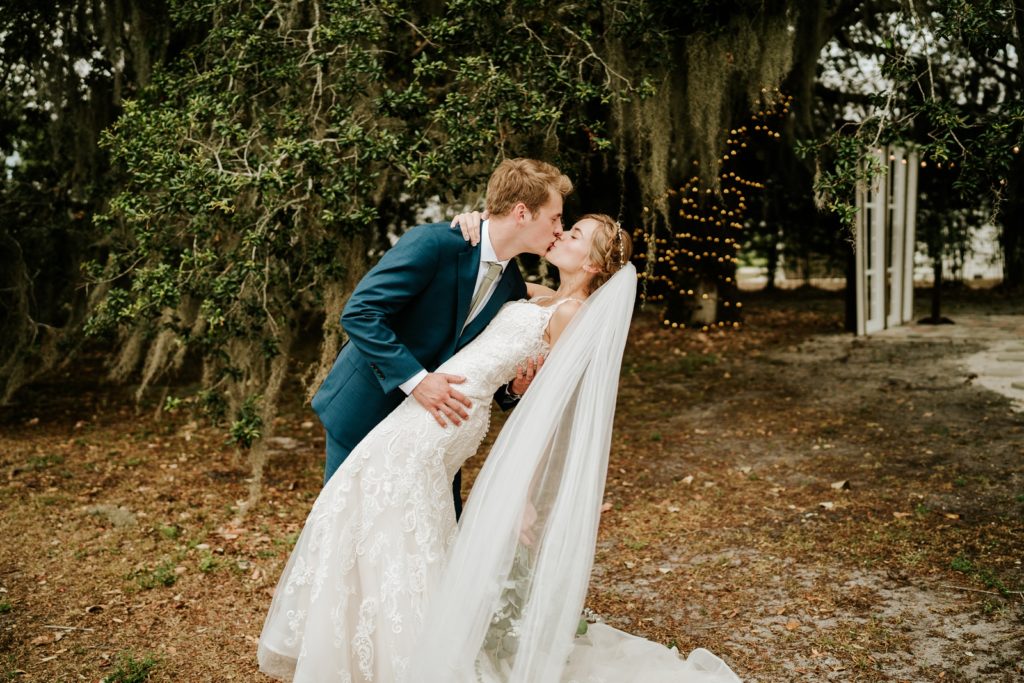 Groom dips bride for a kiss at Ever After Farms Ranch wedding
