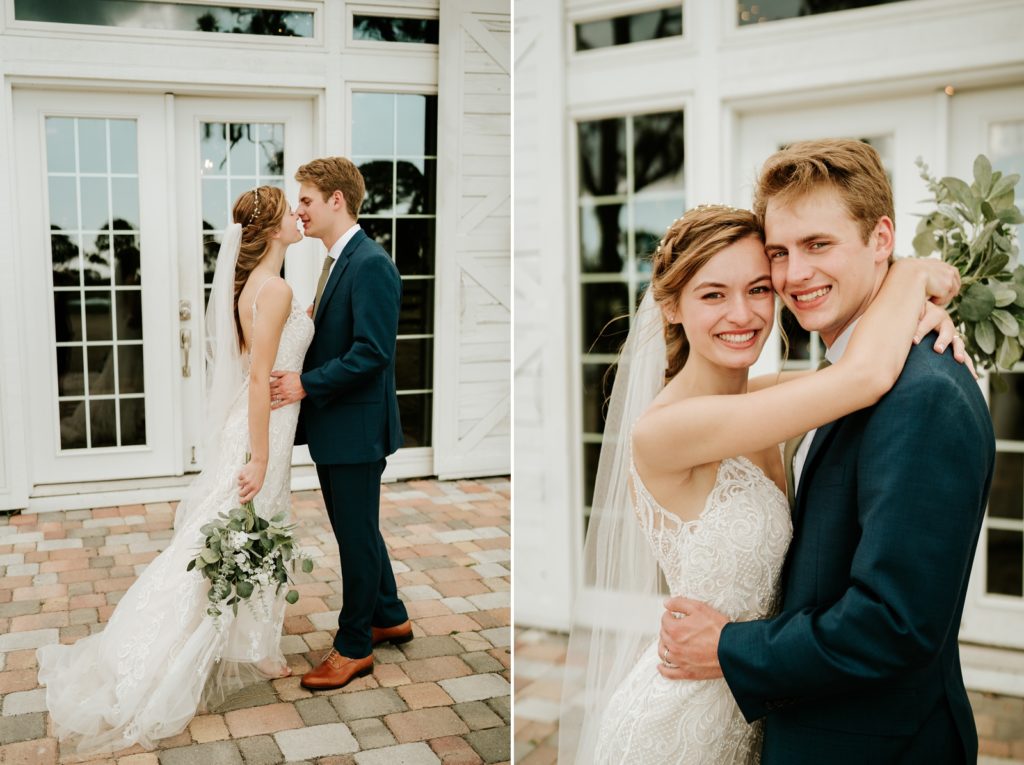 Bride and groom kiss and hug in front of Ever After Farms Ranch white wedding barn glass doors