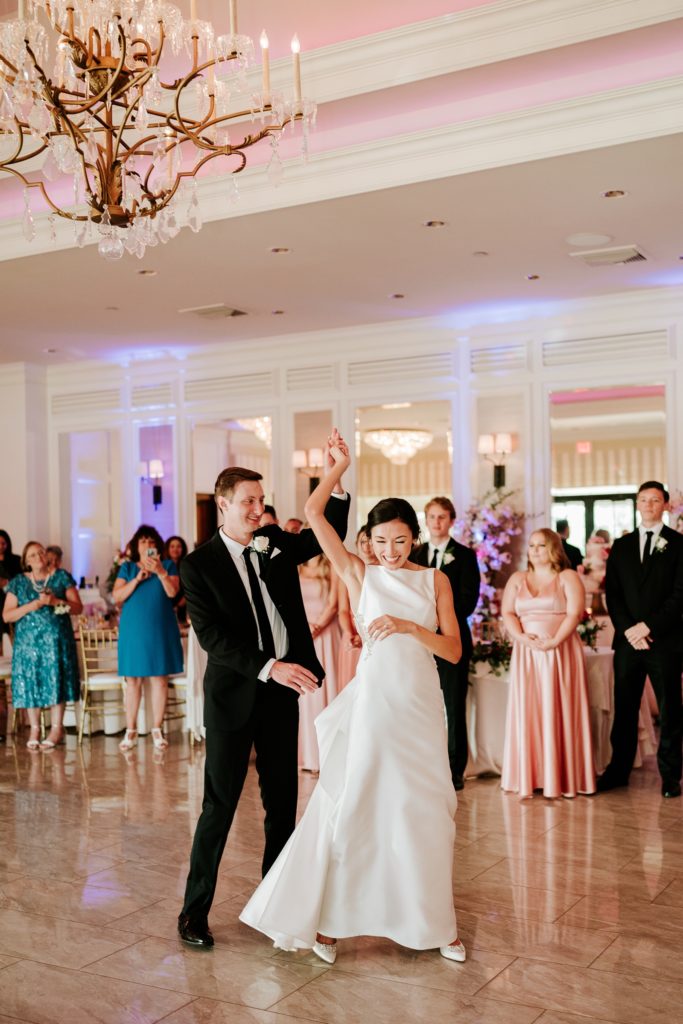 Groom spins bride during first dance at Breakers West Palm Beach FL wedding