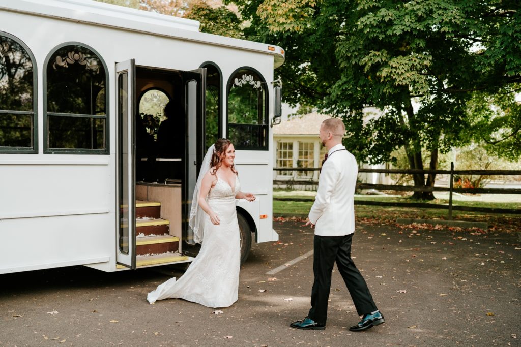 Bride and groom walk to each other after first look with wedding trolley