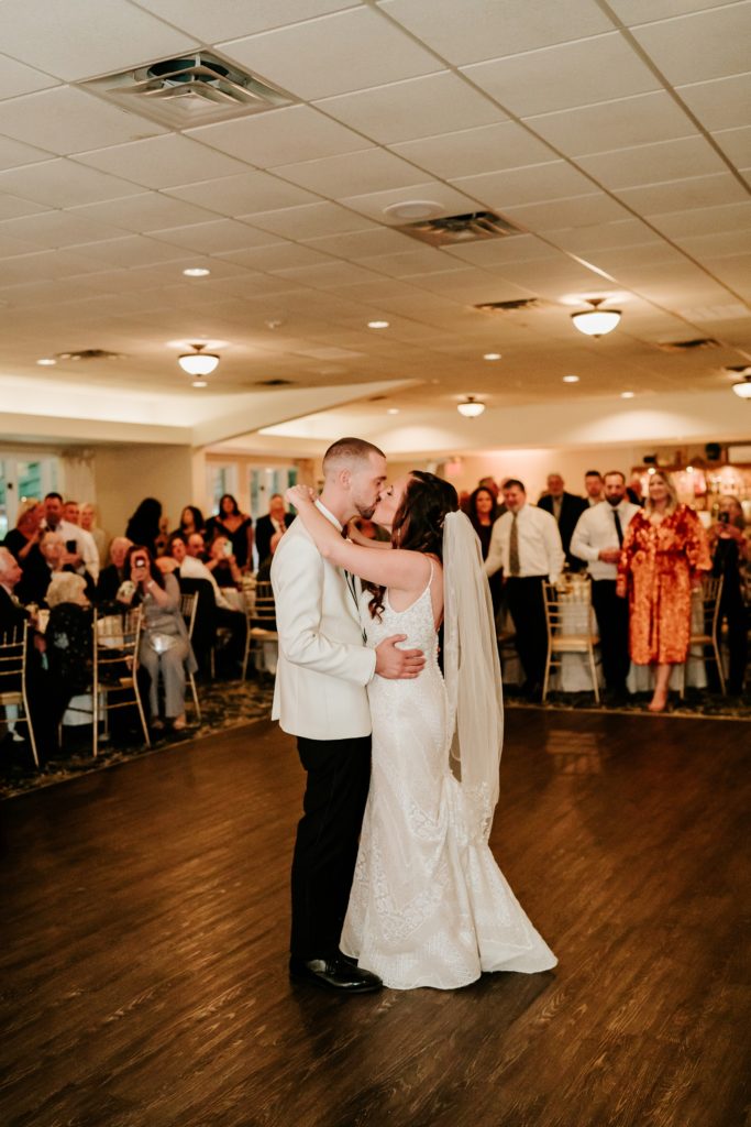 Newlyweds kiss during first dance at Bensalem Township Country Club wedding reception