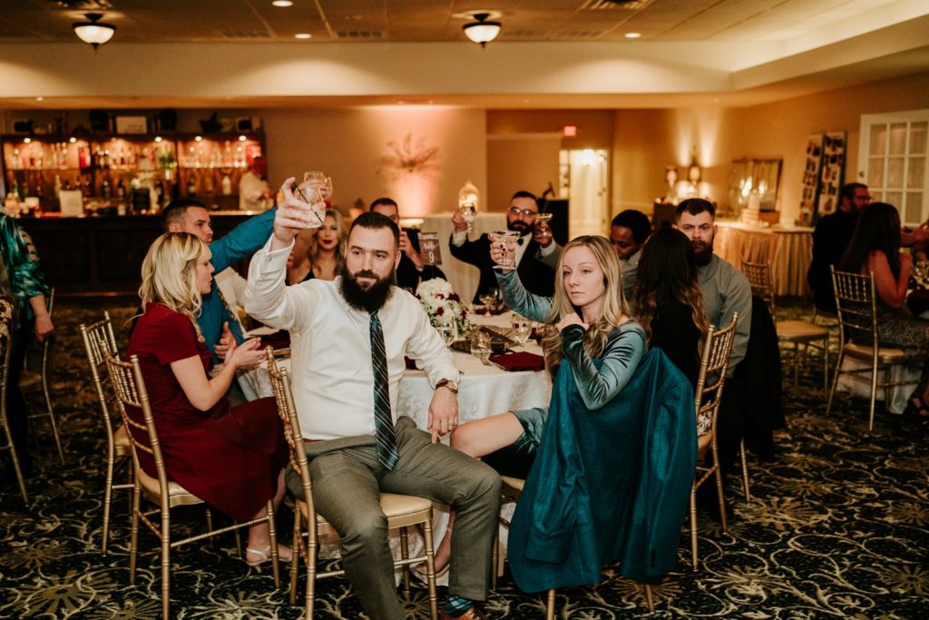 Guests raise glasses during toasts at Bensalem Township Country Club wedding reception