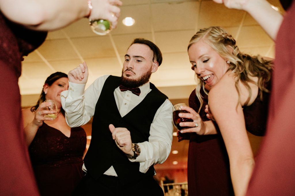 Brother of bride dancing with bridesmaids at Bensalem Township Country Club wedding reception