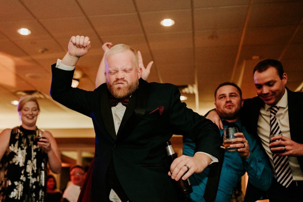 Man pumps fists into air dancing at Bensalem Township Country Club wedding reception