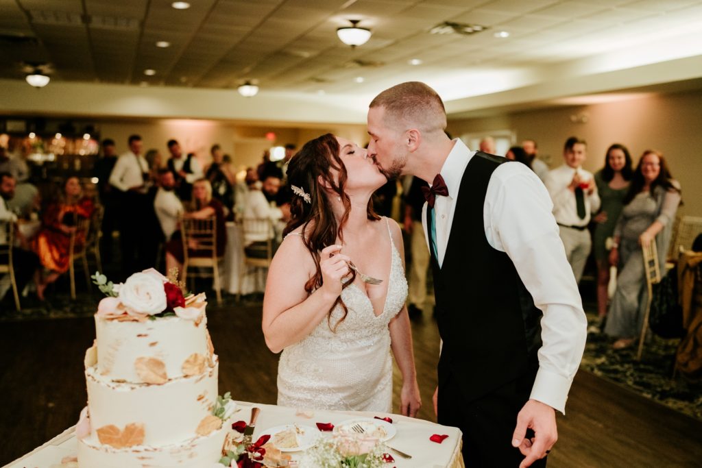 Wedding couple kiss after cake cutting at Bensalem Township Country Club