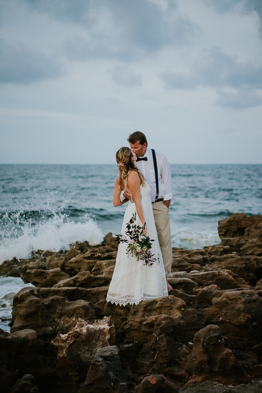 Coral Cove beach elopement wedding couple kiss on rocky beach