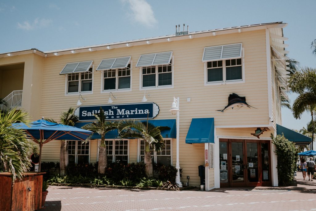 Sailfish Marina Resort Restaurant yellow building with blue awnings