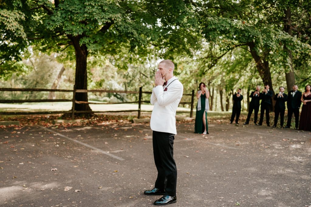 Groom covers mouth when seeing bride for first time during first look