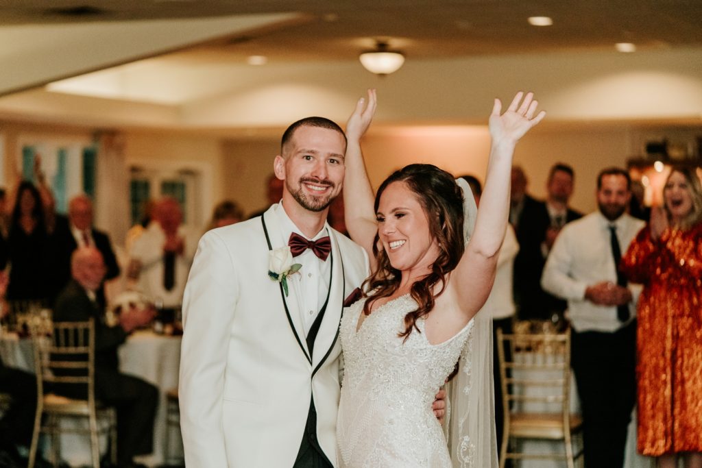 Bride cheers after first dance with groom