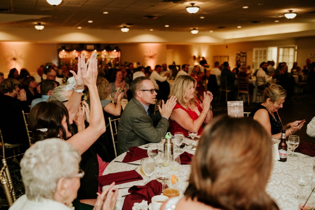 Guests clap after first dance at wedding reception