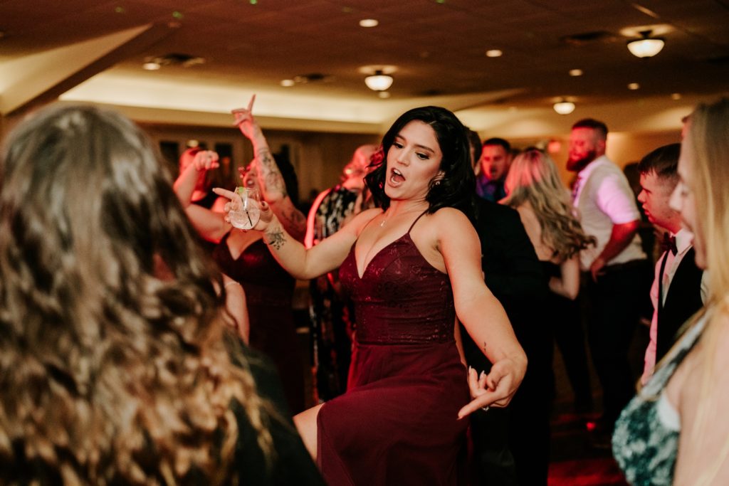Bridesmaid dancing at wild Bensalem Township Country Club wedding reception