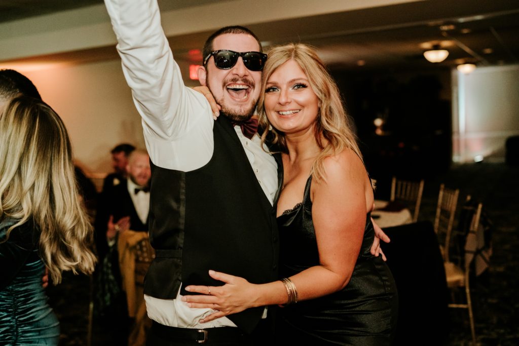 Wedding guests cheer at reception