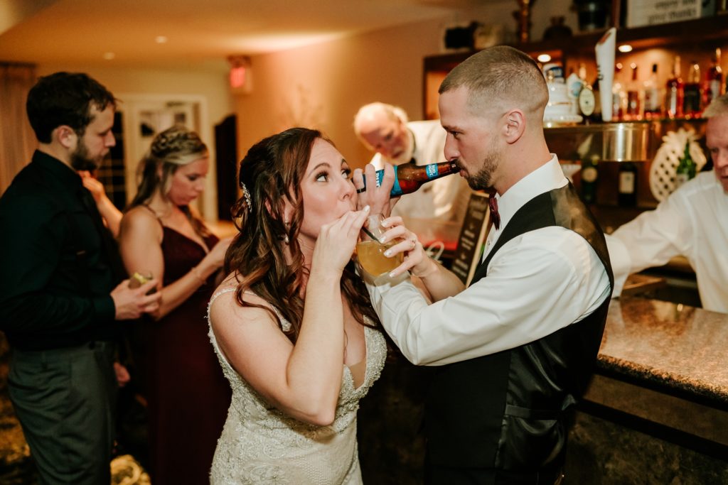 Newlywed couple interlock arms and drink signature cocktails at Bensalem Township Country Club wedding reception