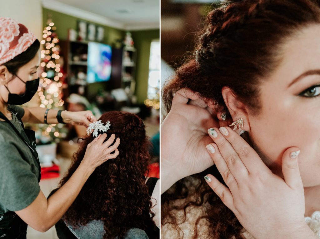 Close up detail of pinning accessory into bride's hair and bride adjusting earring.